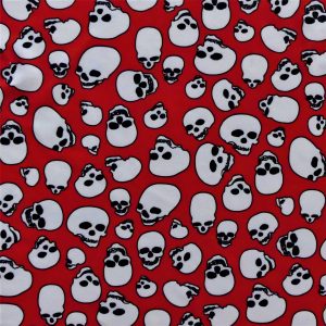 Fabric swatch with white skulls on a red background design